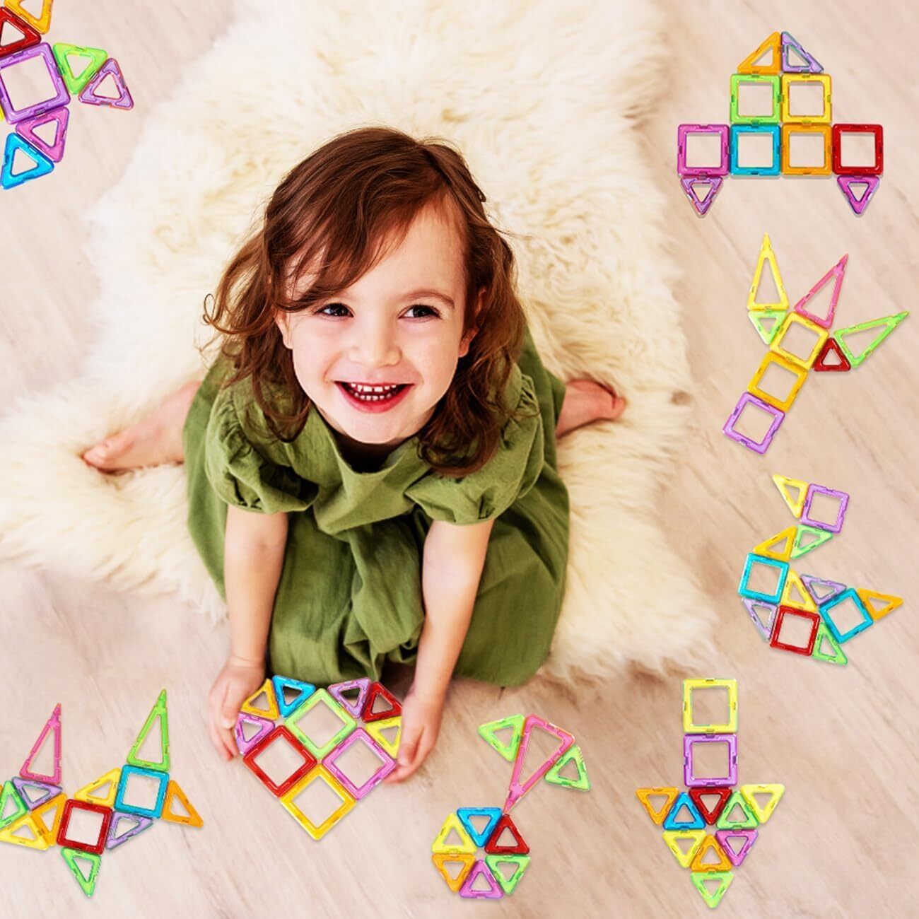 Child playing with colorful magnetic building blocks on a soft surface